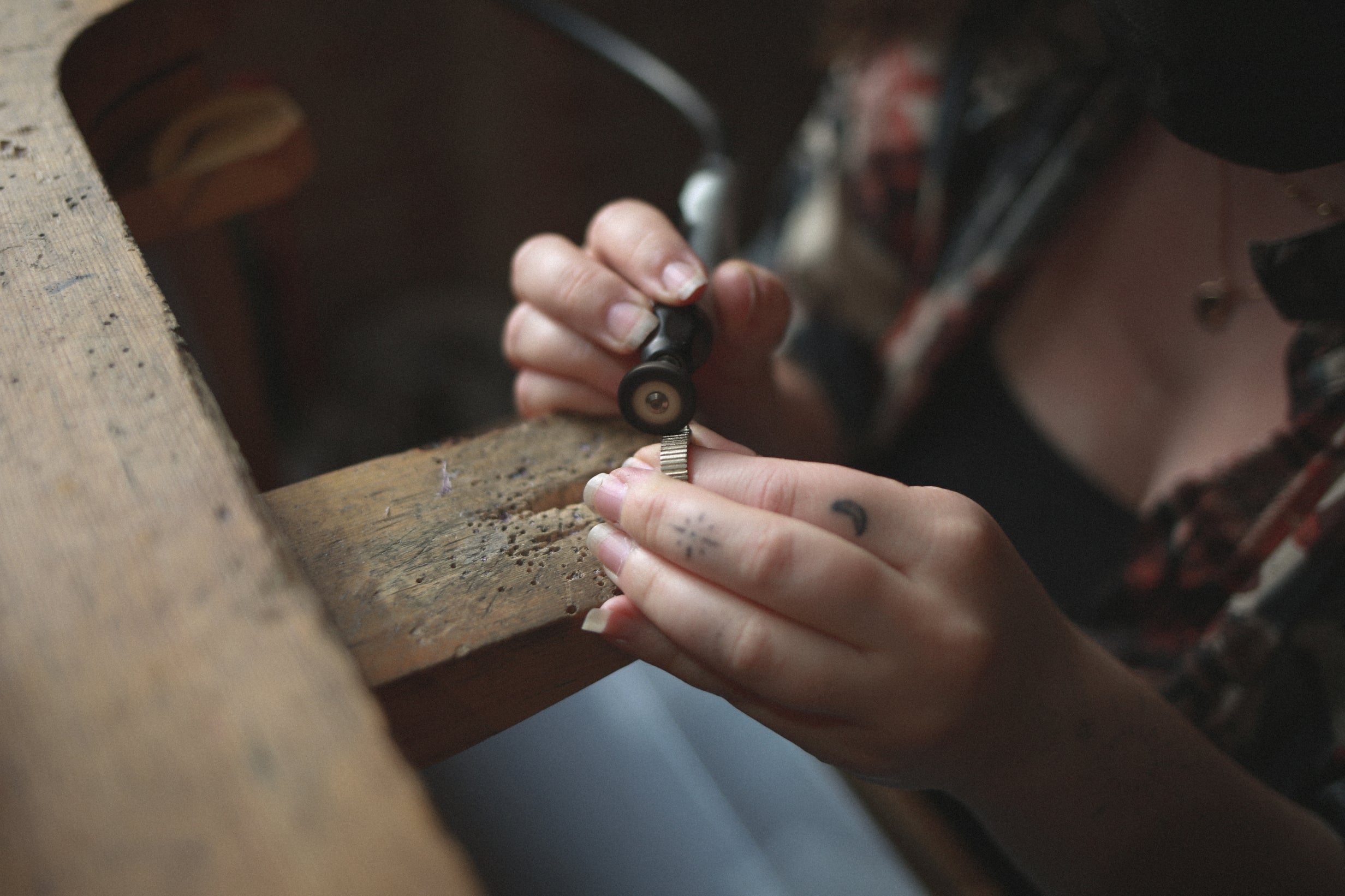 Close us of person polishing a gold ring at jewellery bench