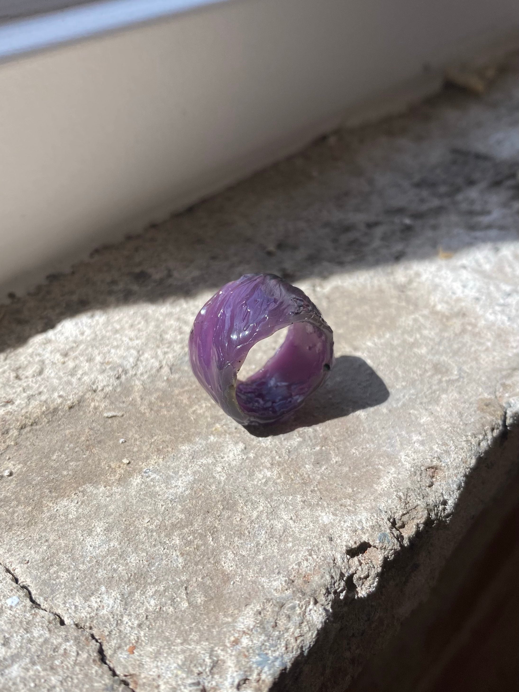Purple jeweller’s wax textured ring model on stone