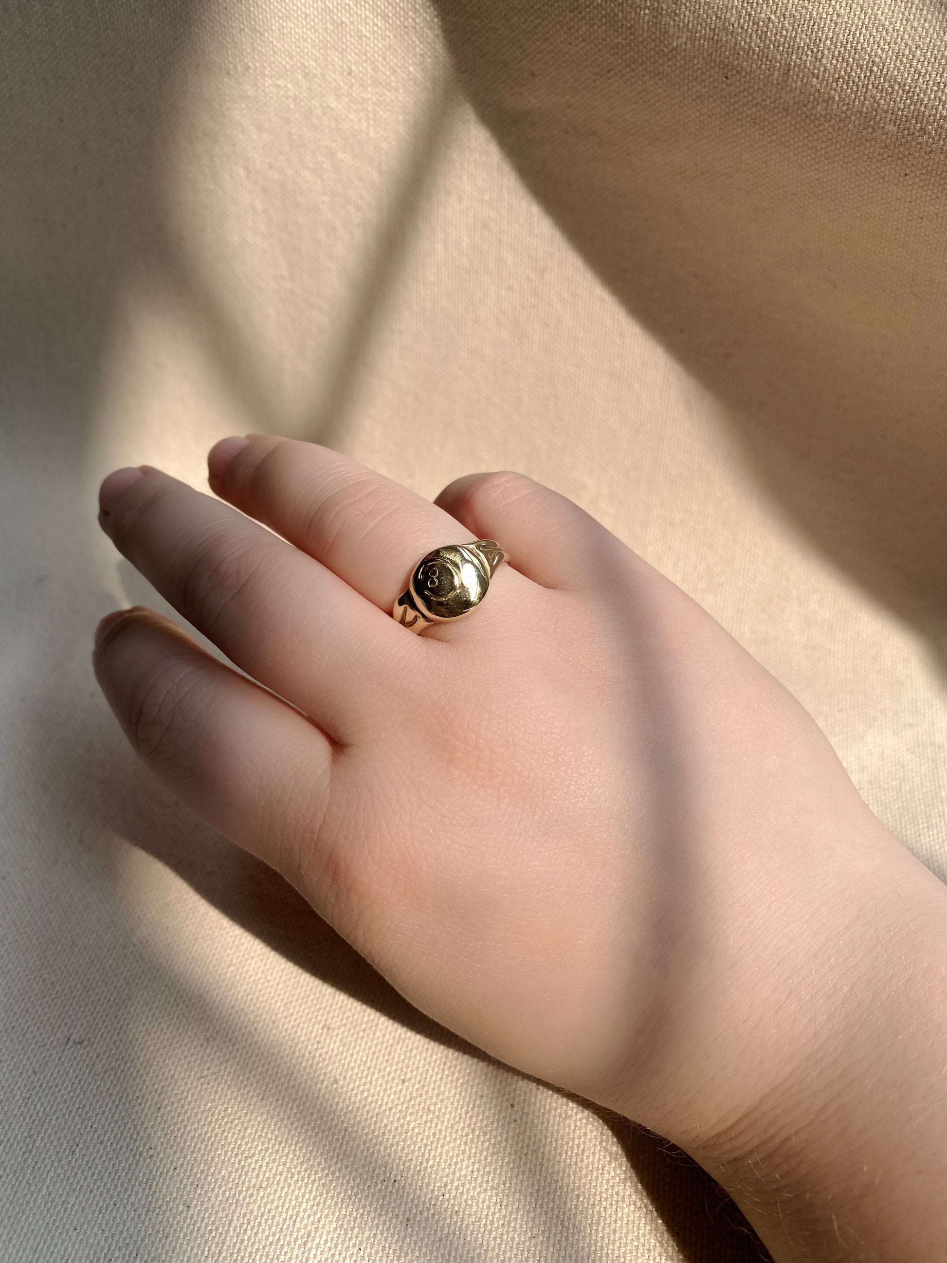 Brass 8 ball ring on hand