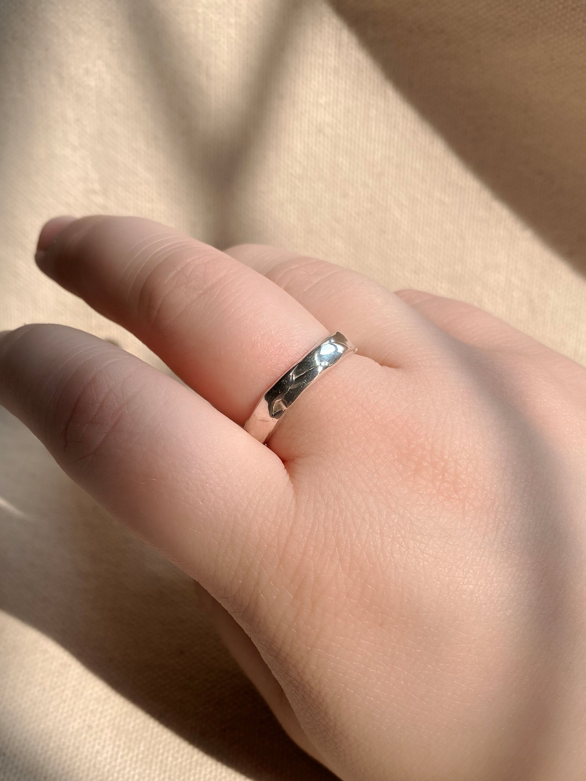 Unique textured silver ring on hand