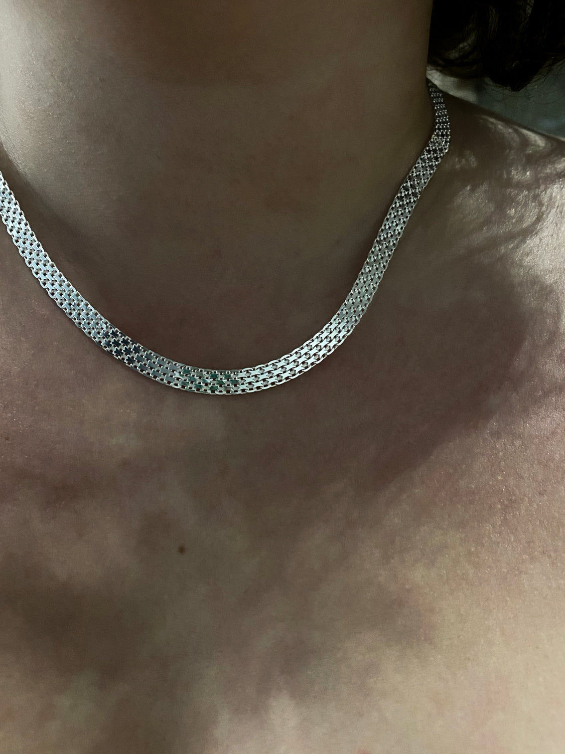Silver checkered link wide chain on model
