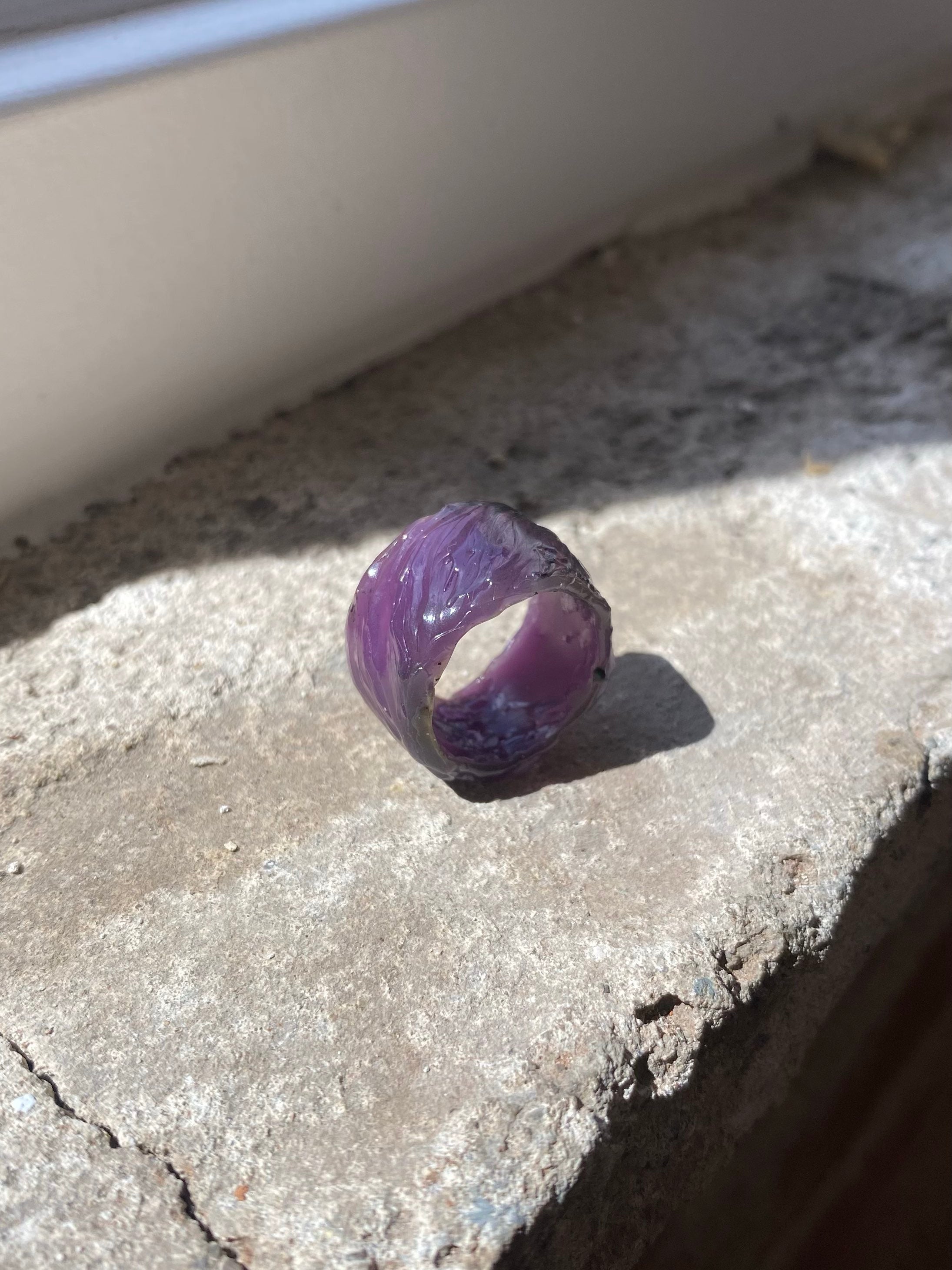Purple jeweller’s wax textured ring model on stone 