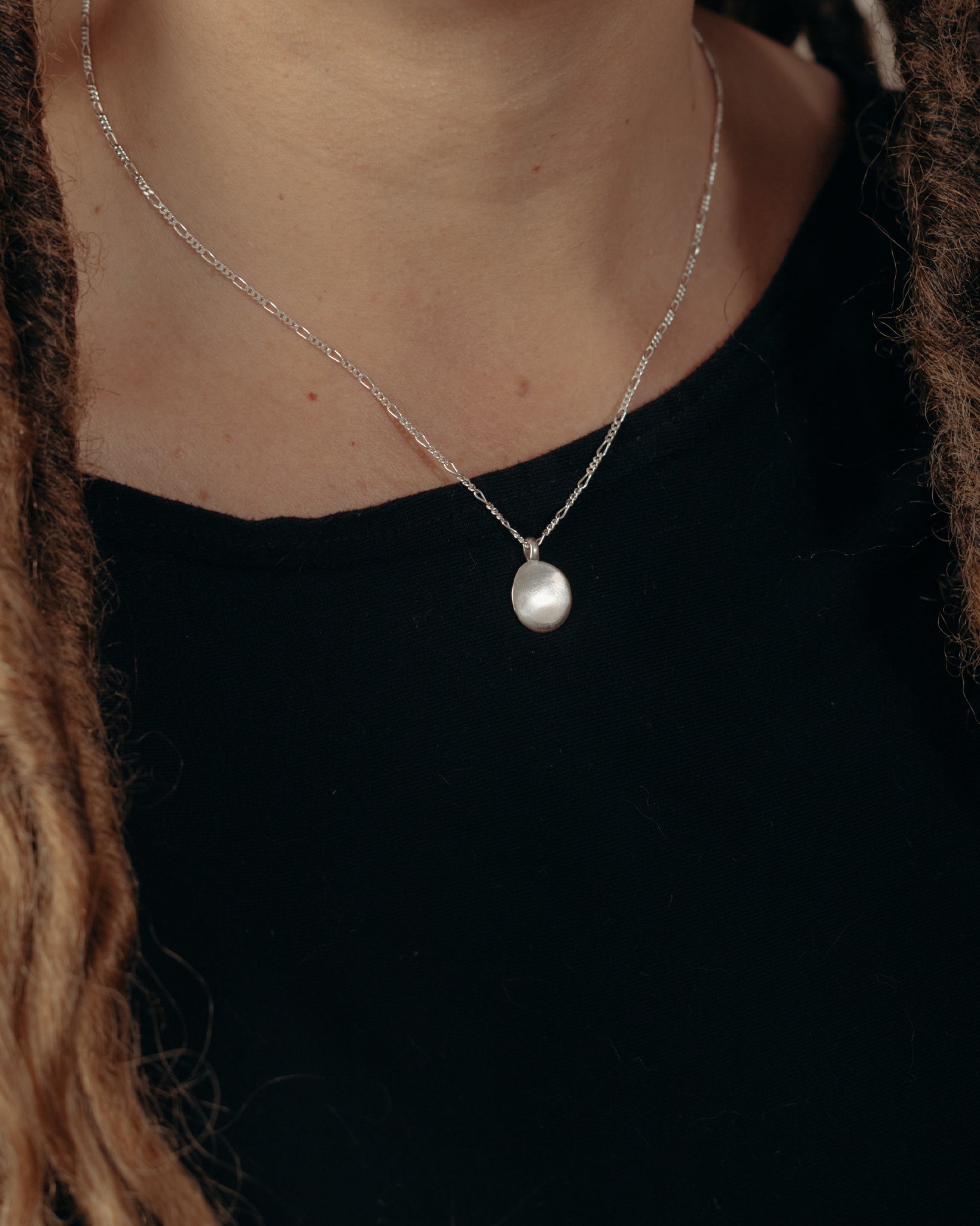 Silver oval pendant necklace on model