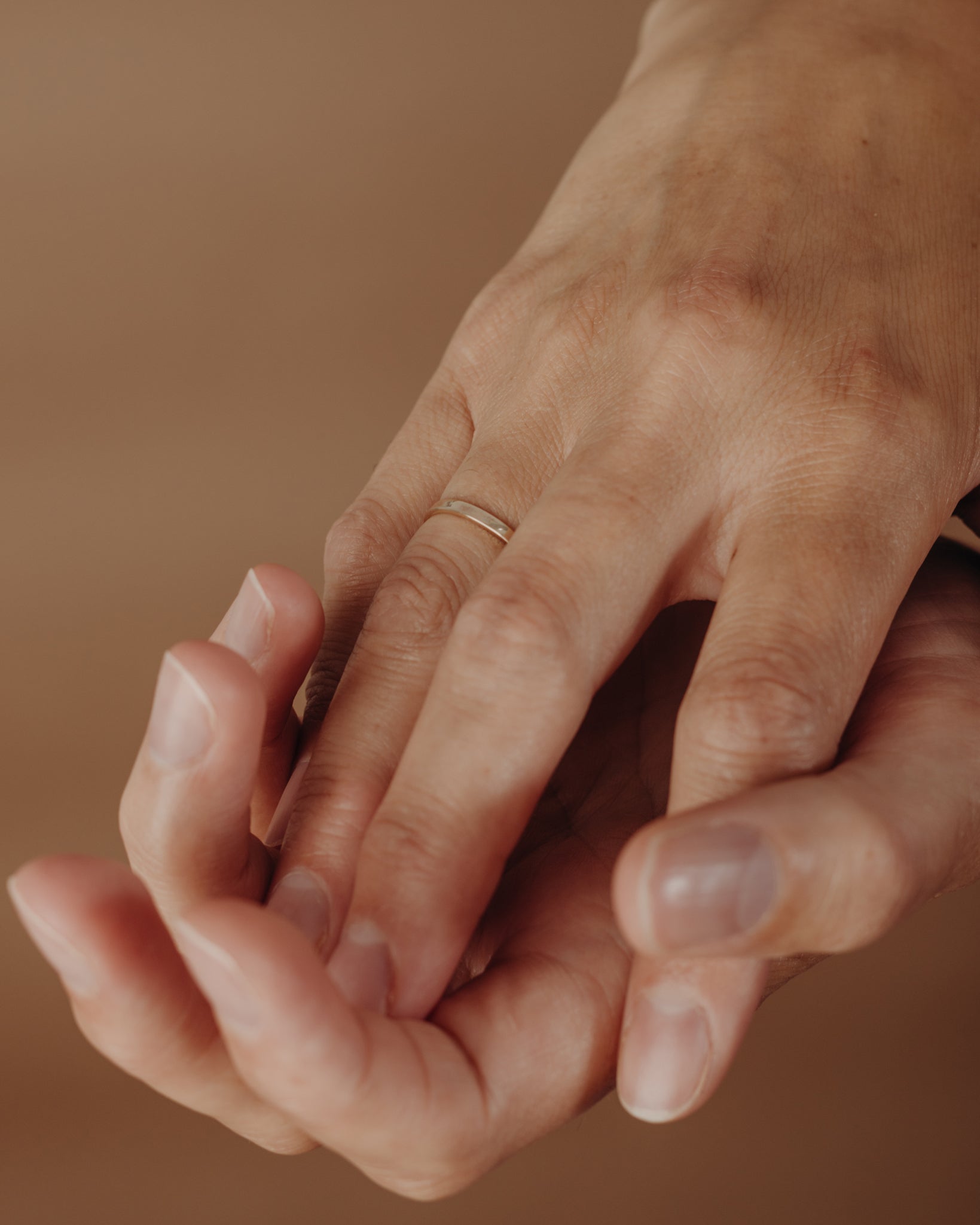 Simple gold flat ring on hand