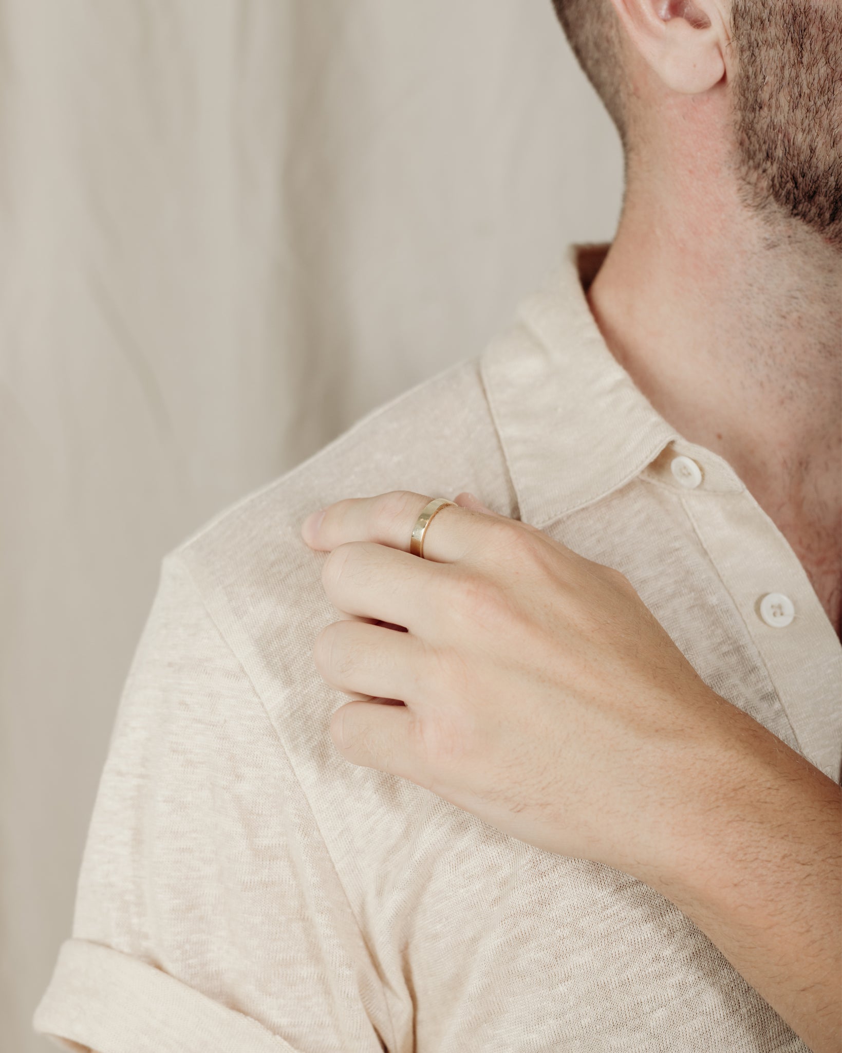 Simple flat gold band on model’s hand