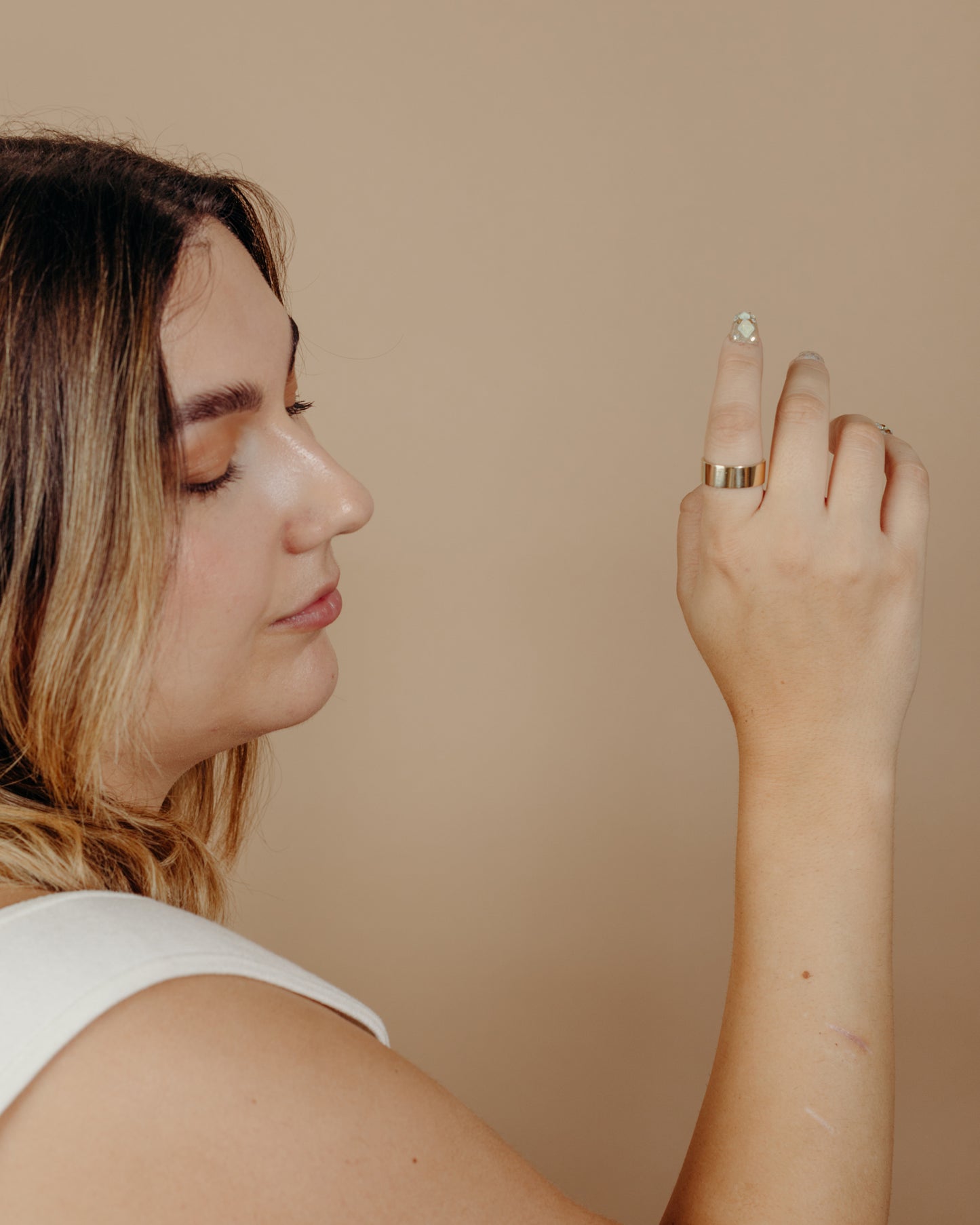 Simple flat gold ring on hand